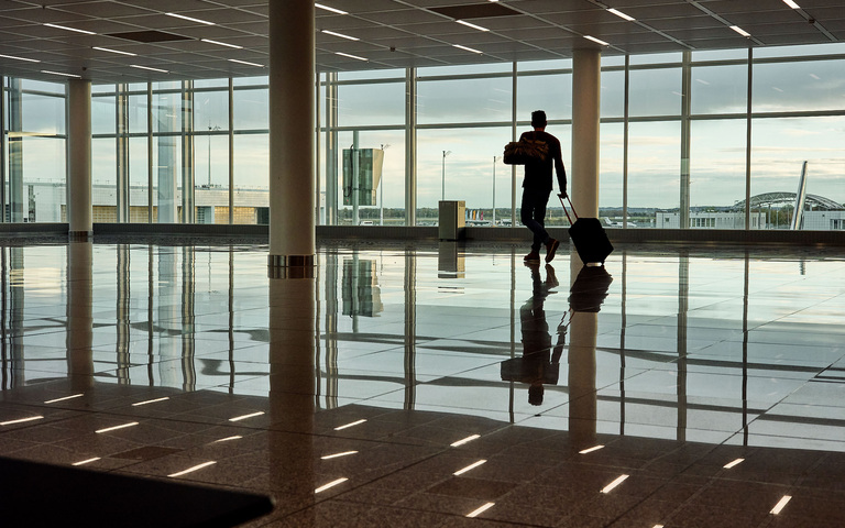 Flughafen-Terminal, Reisender mit Rollkoffer