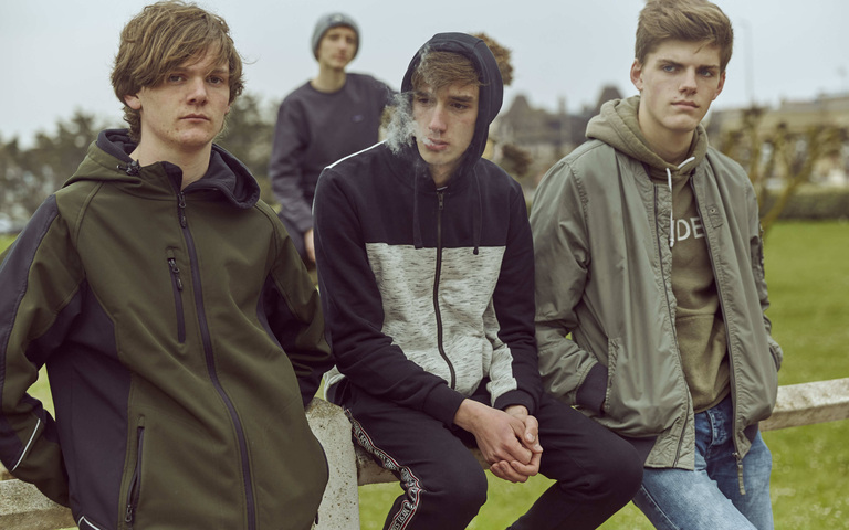 Jugendliche rauchen am Strand