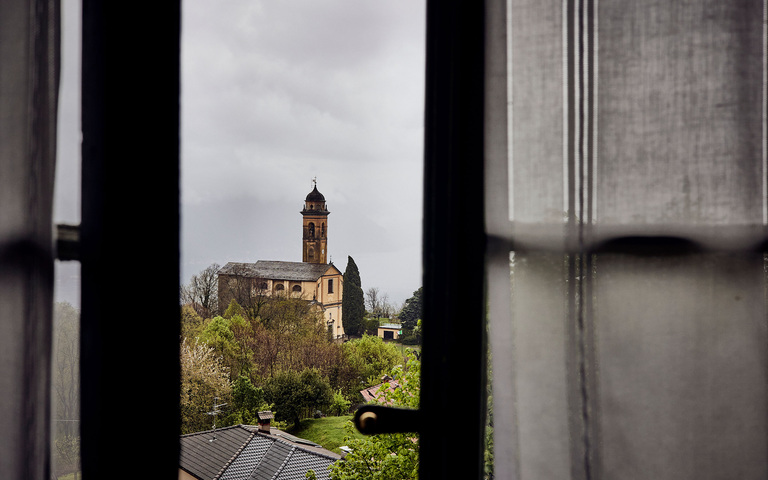Regnerischer Blick auf die alte Kirche in einem oberitalienischen Ort